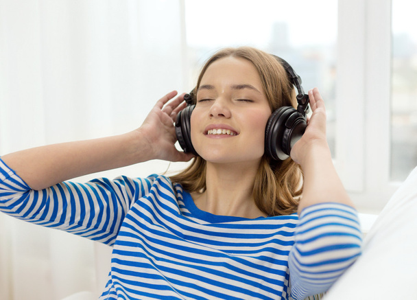 smiling young girl in headphones at home - Photo, Image