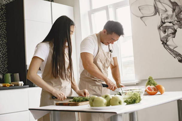 Happy asian couple have fun in modern kitchen indoor - Φωτογραφία, εικόνα