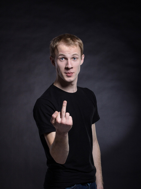 Man in shirt is showing fuck off with the middle finger - Foto, afbeelding