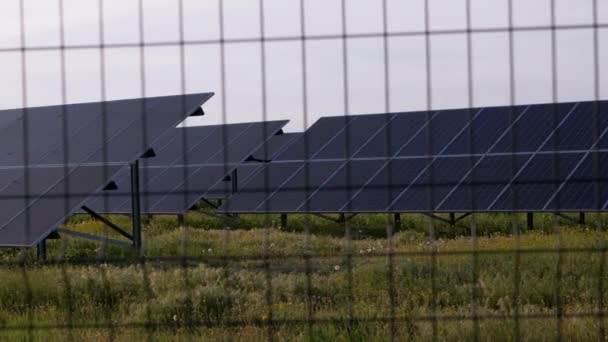 Panneaux solaires clôturés avec clôture en fil de fer barbelé. Piles solaires. 4K - Séquence, vidéo