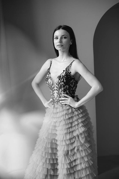 Beautiful woman model posing in elegant dress in the studio - Fotó, kép