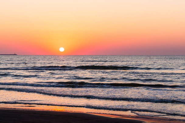 A beautiful sunset sky over the sea - Фото, изображение