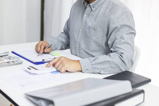 Businessman checking bills taxes bank account balance and calculating annual financial statements of company. Accounting Audit Concept. - Photo, Image