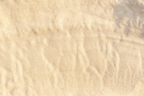 Sandmustertextur für den Hintergrund. Braunes Wüstenmuster vom tropischen Strand. Nahaufnahme. - Foto, Bild