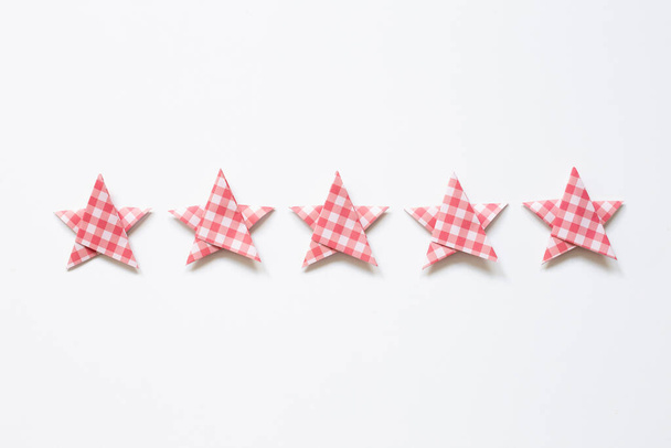 Red check pattern five stars quality rating on white background. top view - Photo, Image