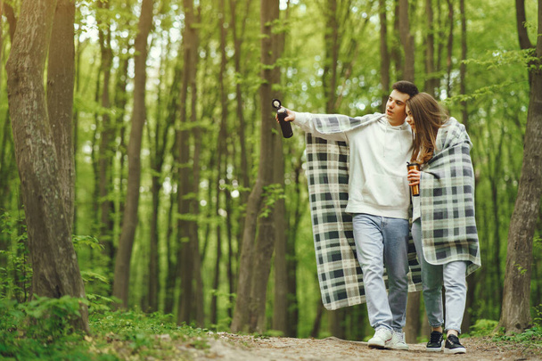 Beautiful couple spend time in a spring forest - Φωτογραφία, εικόνα