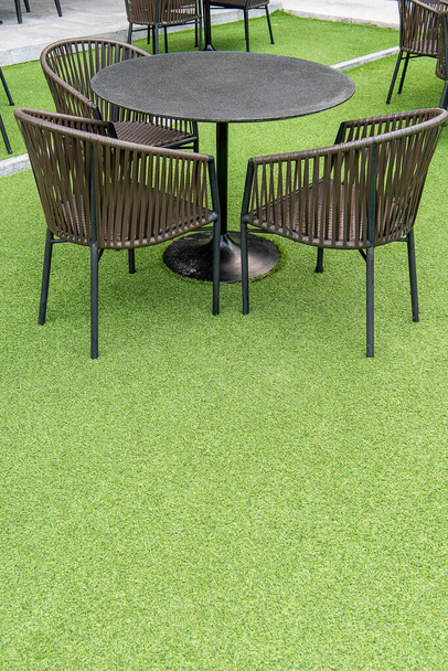outdoor table set. Placed on an artificial green grass, table set for dining decorating with artificial grass circle shape on the floor. - Fotó, kép