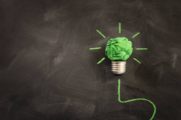 Concept image if green crumpled paper lightbulb, symbol of scr, innovation and eco friendly business - Fotoğraf, Görsel