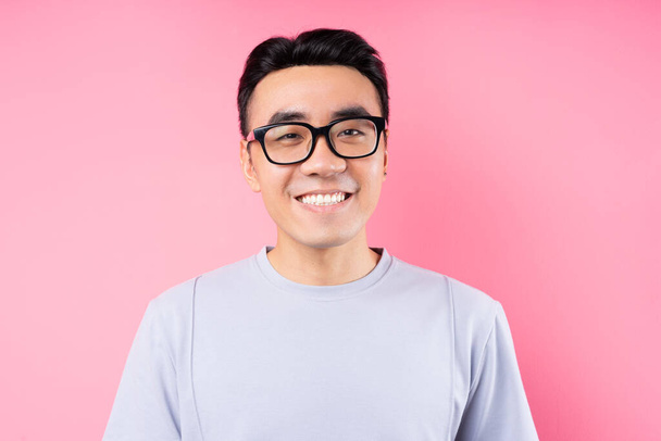 Portrait of Asian man posing on pink background with many expression - Photo, image