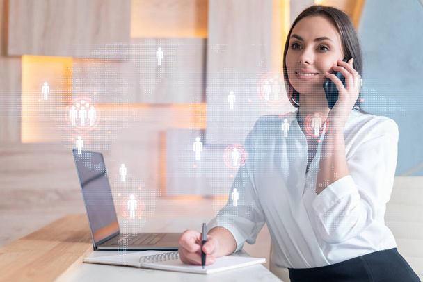 Attractive businesswoman in white shirt has conference call to hire new employees for international business consulting. HR, social media hologram icons over office background - Фото, зображення