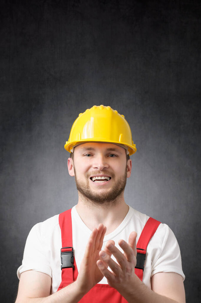 Portrait of a construction worker clapping his hands - 写真・画像