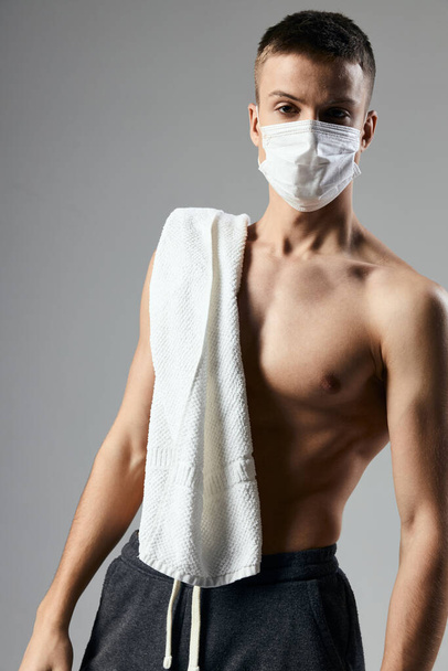 sport man medical mask safety white towel on shoulders cropped view - Foto, Imagem