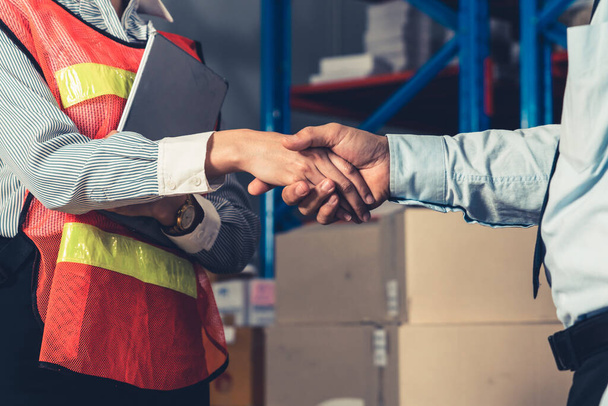 Warehouse worker handshake with manager in storehouse - Φωτογραφία, εικόνα
