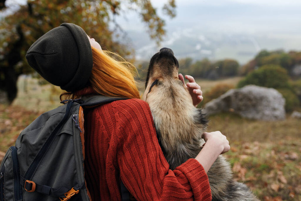 cheerful woman tourist playing with dog nature fresh air - Valokuva, kuva