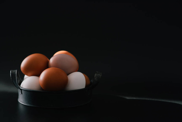 Chicken eggs in vintage tray on a black background. Organic, biological, bio products, bio ecology, healthy. - Zdjęcie, obraz
