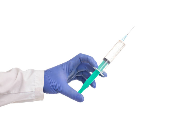 Doctor holding a syringe with medicine in hand on white background, isolate - Foto, afbeelding