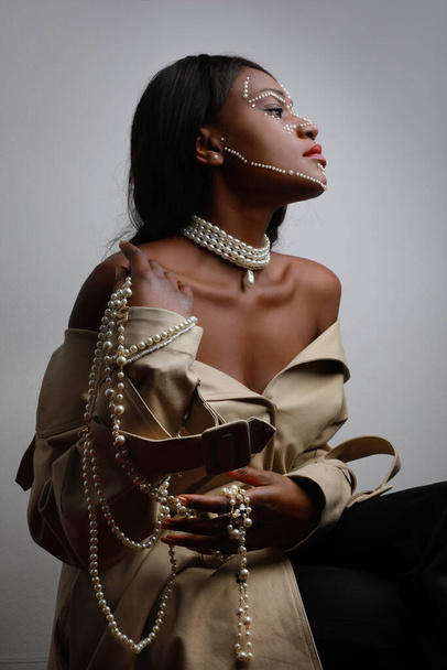Vertical portrait of attractive black woman with pearl necklace. Isolated. - Foto, immagini