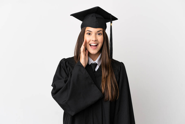 Teenager Brazilian university graduate over isolated white background shouting with mouth wide open - Fotó, kép
