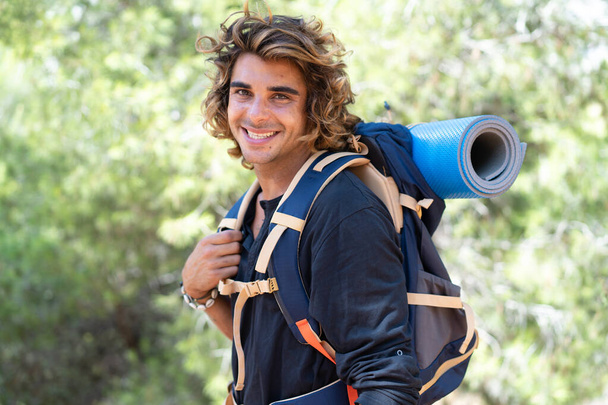 Young caucasian hiker man spending their camping vacations - 写真・画像