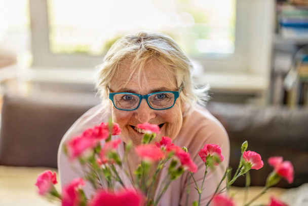 Happy senior woman smiling at home - Fotografie, Obrázek