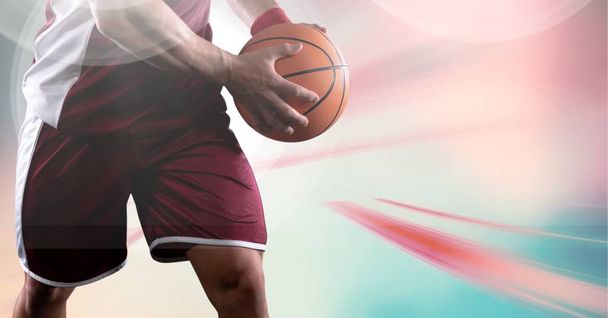 Composition of midsection of basketball player holding ball with copy space. sport and competition concept digitally generated image. - Foto, Imagem