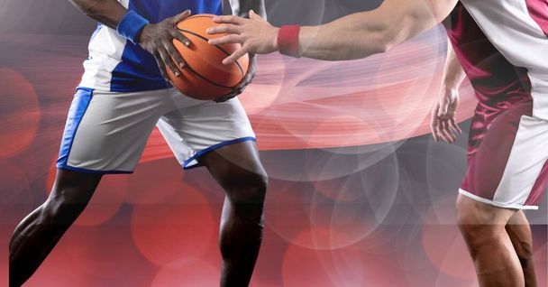 Composition of midsection of basketball players holding ball with copy space. sport and competition concept digitally generated image. - Foto, immagini