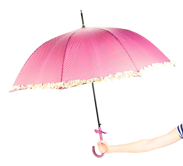 Pink umbrella in hand, isolated on white - Fotó, kép