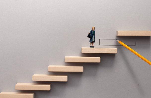 Pencil sketch bridging the gap between wooden steps for female miniature figure to climb - Fotoğraf, Görsel