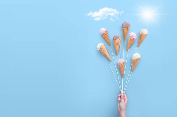 Hand holding ice cream cones like balloons, summer ice cream concept - Φωτογραφία, εικόνα