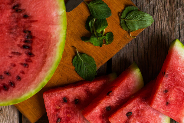 Refreshing watermelon on a rustic wooden background. Slices of juicy ripe red watermelon. - Fotoğraf, Görsel