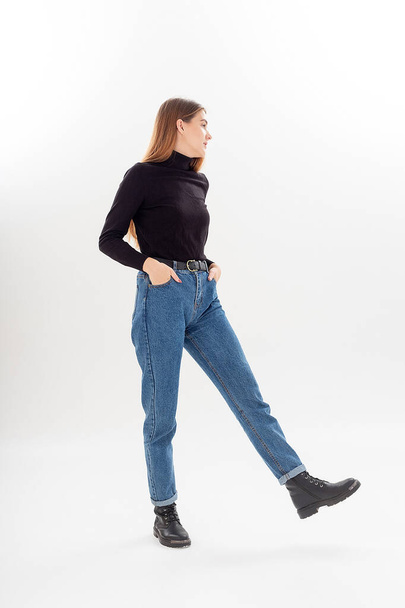 young attractive caucasian woman with long hair in black turtleneck, blue jeans - Fotografie, Obrázek
