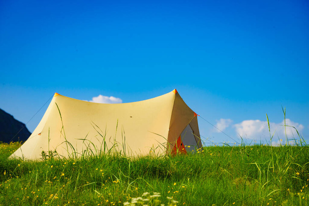 Camping. Tent on nature against blue sky. Holidays and travel. - Фото, зображення