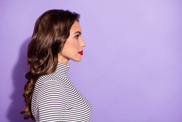 Profile side photo of serious young woman look empty space wear striped turtleneck isolated on purple color background - 写真・画像