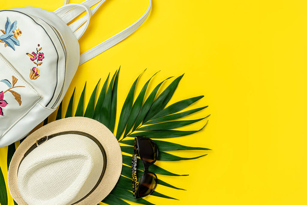 Female summer accessories on bright yellow background. Top view, copy space. - Photo, Image