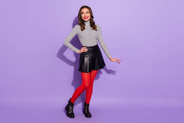 Photo of pretty adorable young woman wear striped outfit walking arm waist looking empty space isolated violet color background - Φωτογραφία, εικόνα