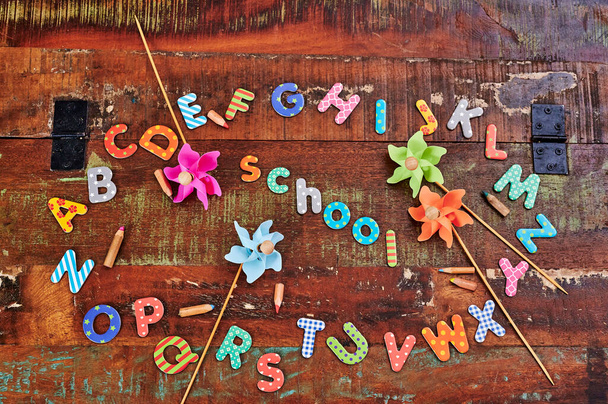 Auburn fa asztal színes betűkkel, amelyek mutatják az ábécé fekvő körben. - Fotó, kép
