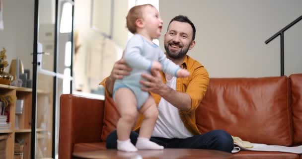 Middle aged dad carrying and playing with newborn baby - Footage, Video