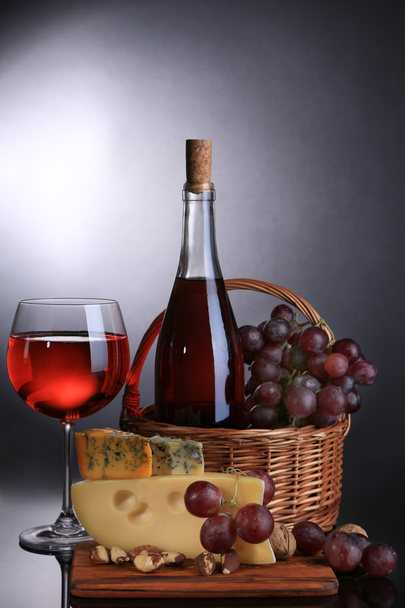 Pink wine, grapes and cheese on black background - Foto, imagen