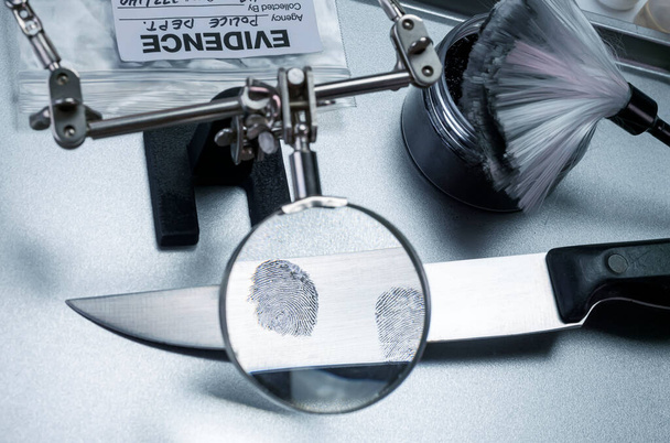 Police investigation of fingerprint on a knife, concept image - Photo, Image