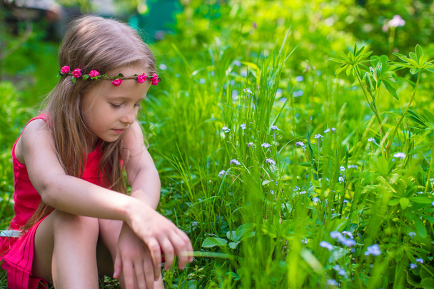 Happy little girl enjoy summer day in the garden - Photo, image