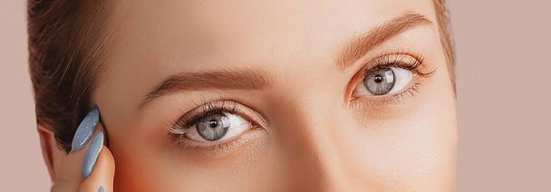 Beautiful sensual young girl with clean skin. Female eyes close-up shot. Woman looking at the camera. The concept of spa treatments, natural beauty and care, youth, cream and mask, freshness - Fotoğraf, Görsel