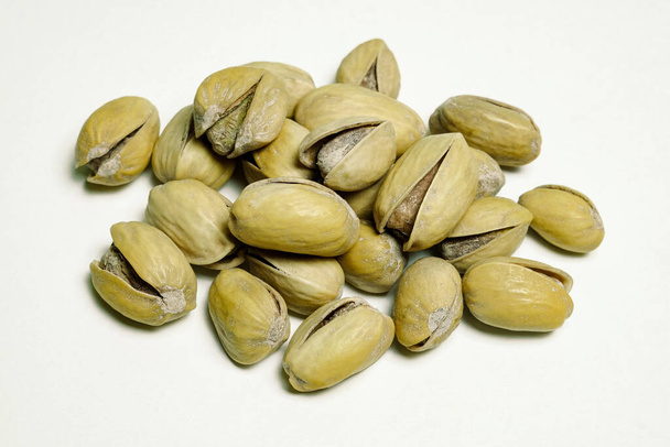 pistachio nuts with peel, photographed by macro photography on a white background - Fotografie, Obrázek