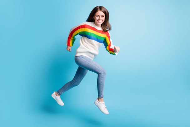 Full length body size view of pretty cheerful girl jumping running fast achievement isolated over bright blue color background - Photo, image