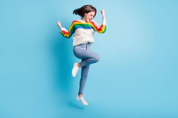 Full length body size view of pretty cheerful girl jumping rejoicing attainment isolated over bright blue color background - Φωτογραφία, εικόνα