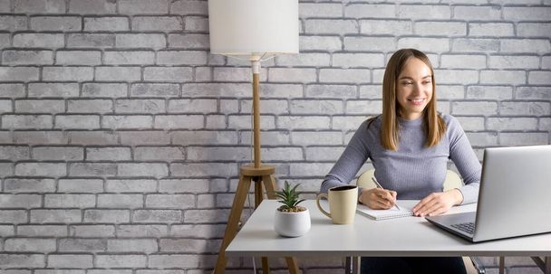 Woman Writing In Notepad And Using Laptop At Home Or Office. Banner. - Photo, Image