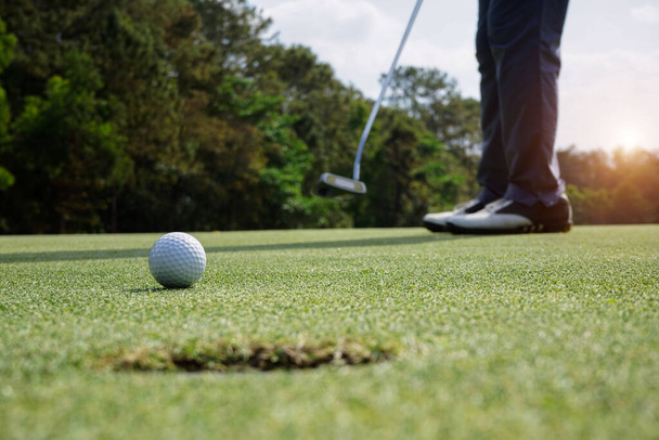 Blurred Golfers are putting golf in the evening golf course golf backglound.                                - Foto, Bild