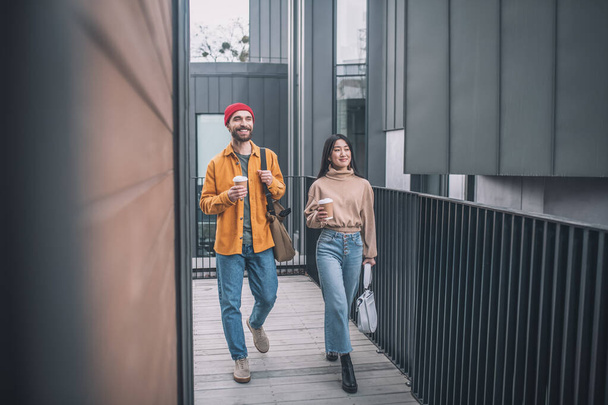 Young man and woman in casual clothes walking together - Photo, Image