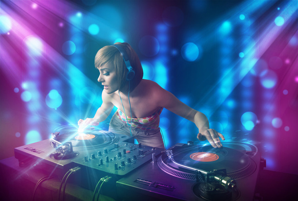 Dj tyttö sekoittamalla musiikkia klubilla sininen ja violetti valot
 - Valokuva, kuva