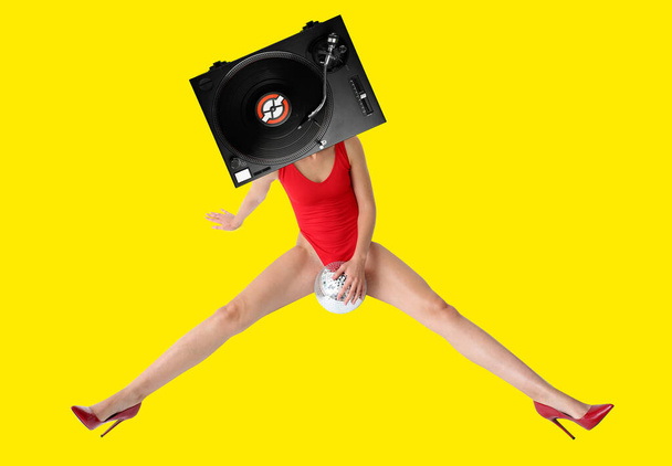 Sexy woman with DJ vinyl record player instead of head on color background - Fotografie, Obrázek