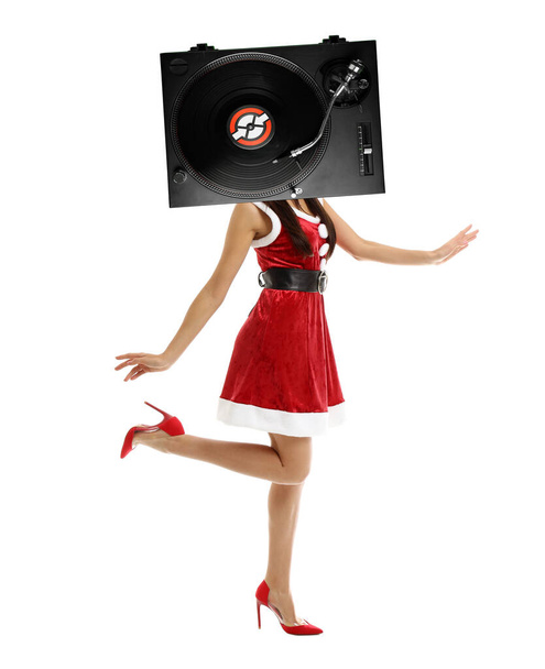 Young woman in Santa Claus costume and with DJ vinyl record player instead of head on white background - 写真・画像
